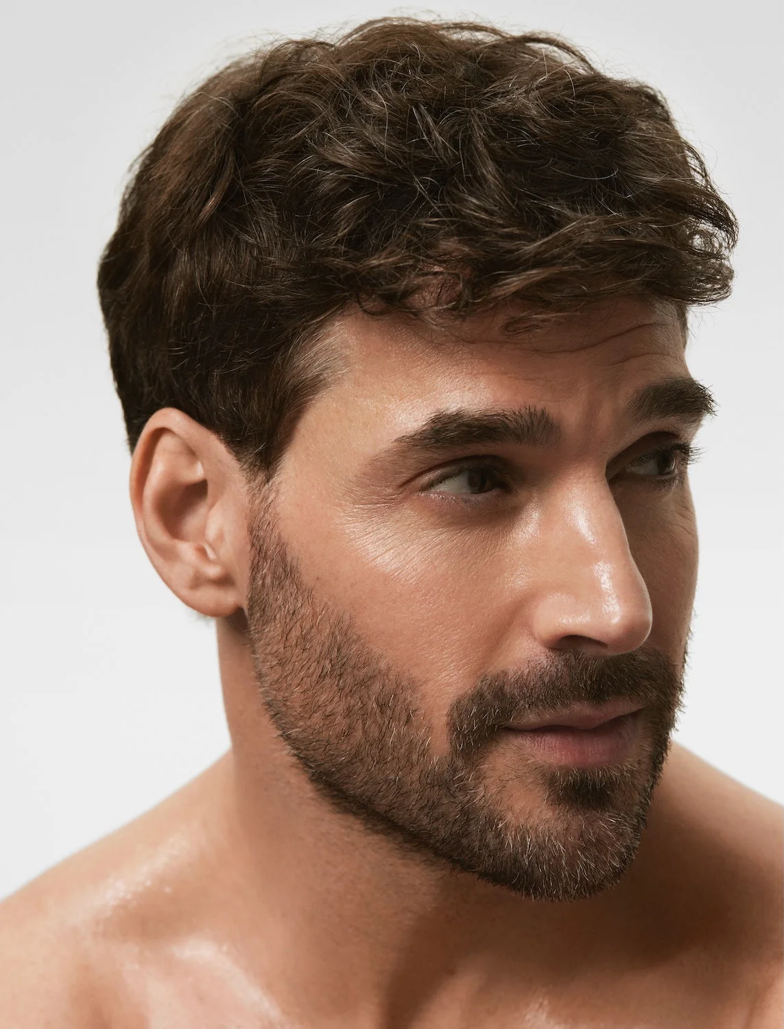 Portrait of a man with short dark hair and a beard