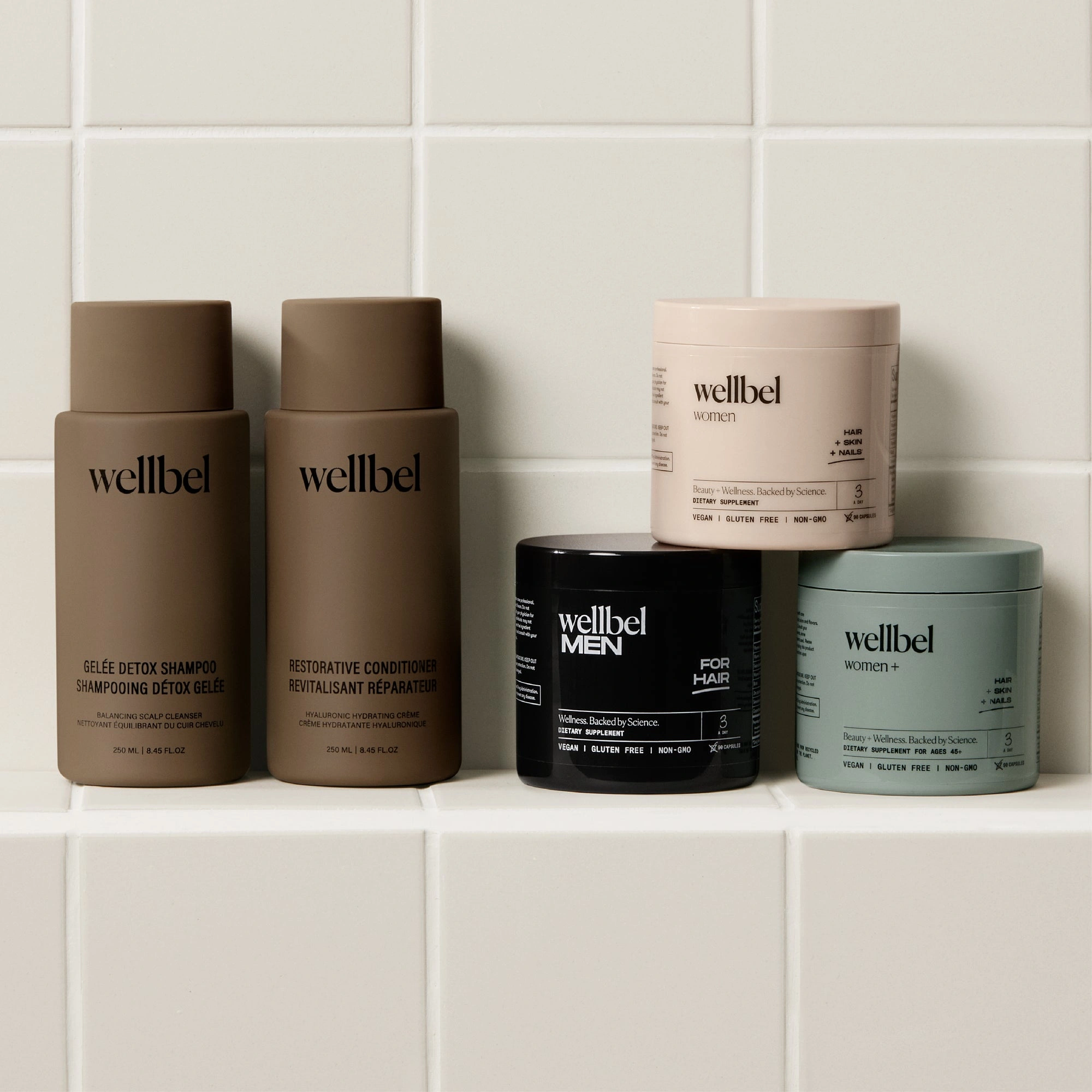 Wellbel Gelée Detox Shampoo, Restorative Conditioner, Women, Men and Women+ on a tiled shelf