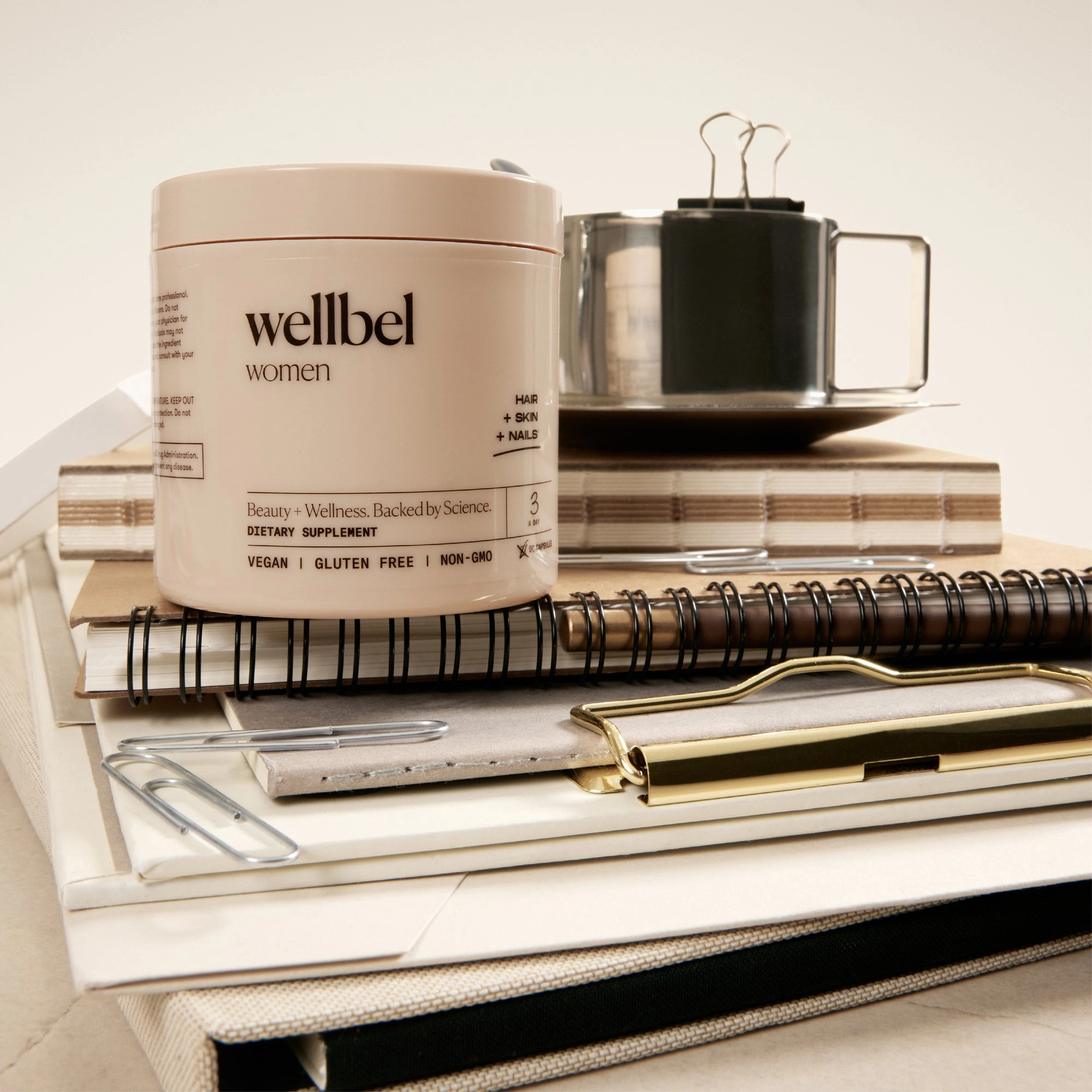 A Wellbel Women jar resting on a stack of magazines