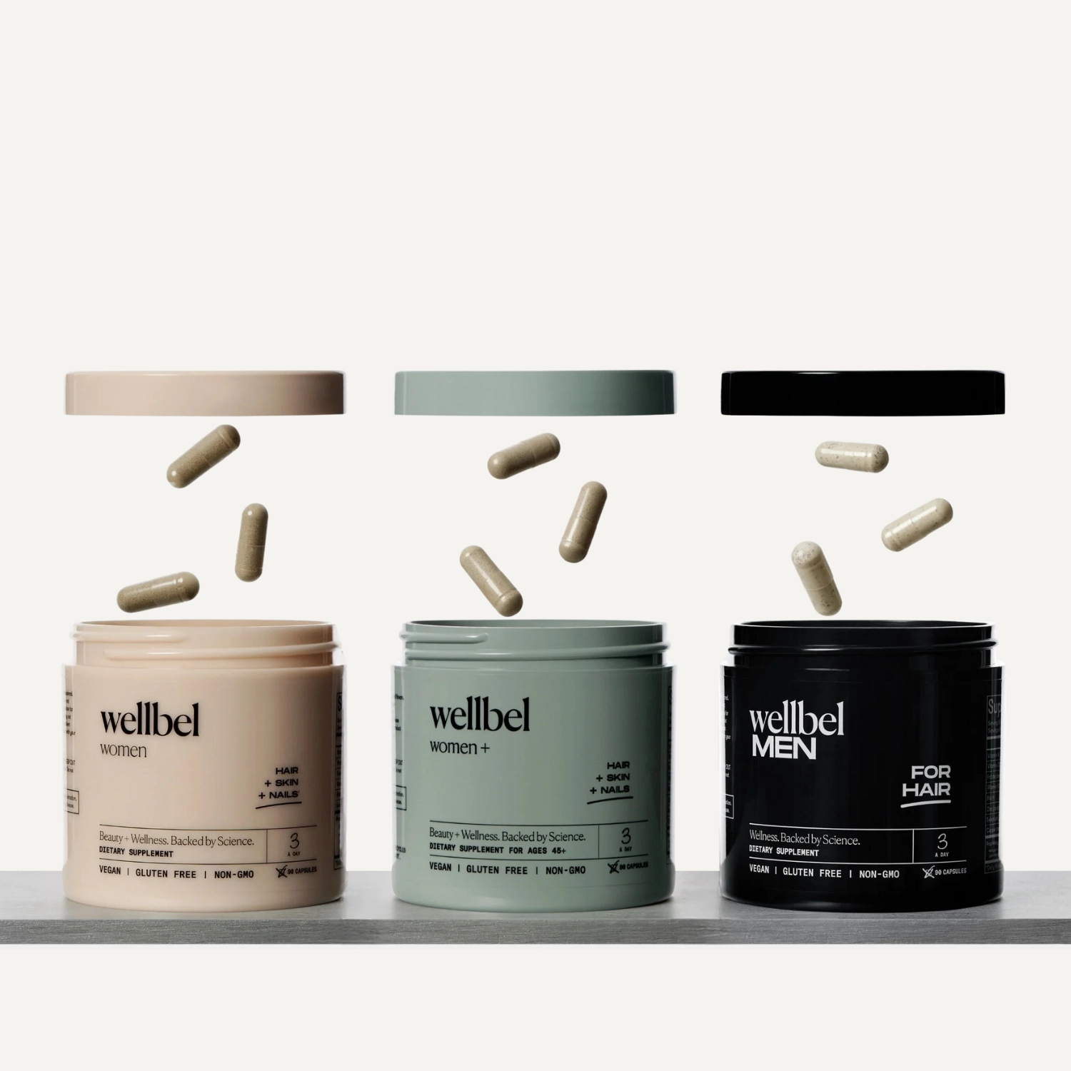 Three Wellbel jars with capsules floating above them